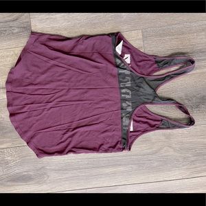 A pink tank tee with the brand name written along the chest.